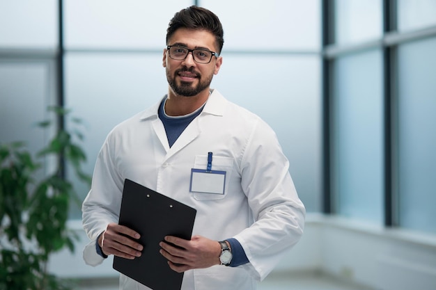 Experienced doctor with a folder in his hands l