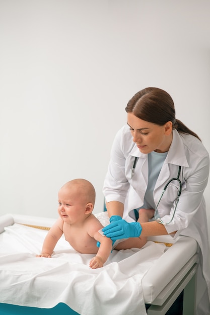 experienced healthcare professional preparing a child for a shot