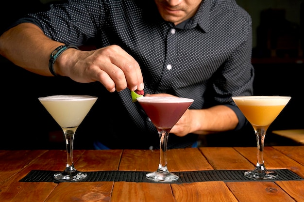 Expert barman making cocktails