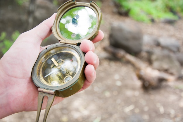 exploring the forest with a compass in hand