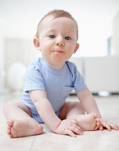 Exploring the living room A baby boy sitting on the living room floor