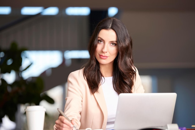 Exploring modern technology Shot of a confident businesswoman working on tablet while sitting at office