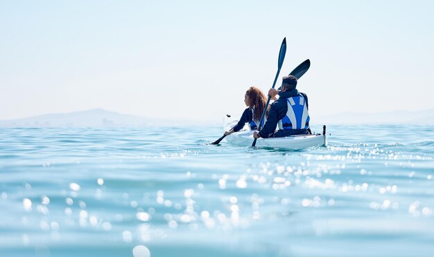 Exploring the scenic lakeside Rearview shot of a young couple kayaking together at a lake