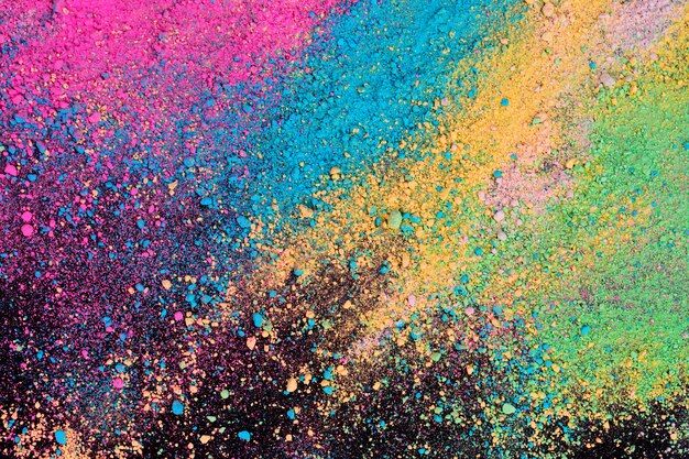 An explosion of colorful pigment powder on black background.