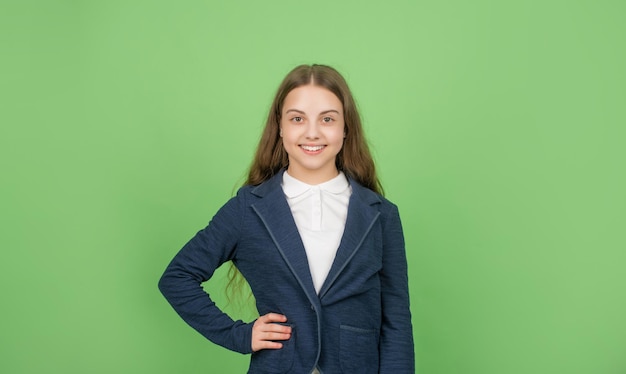 Express emotions. cheerful teen girl. back to school. knowledge day. childhood education. kid in uniform. september 1. child on green background.