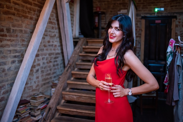 Expressive beautiful woman posing in evening dress