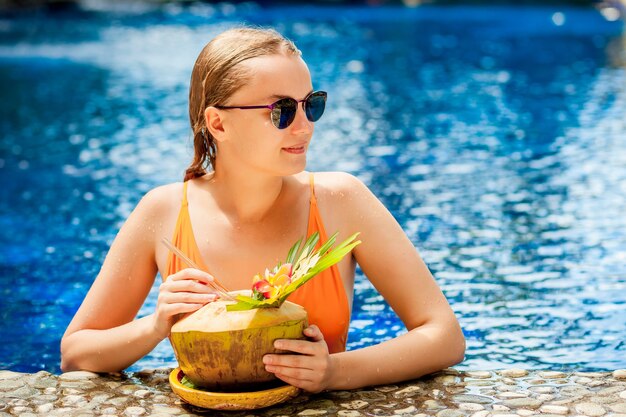 Expressive beautiful woman posing in the swimming pool