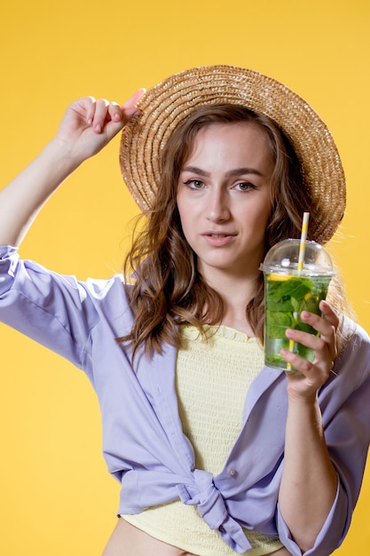 Expressive beautiful woman posing with a glass of beverage