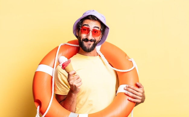 Expressive crazy bearded man wearing hat and sunglasses with an ice cream