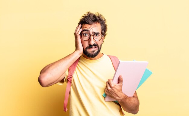 Expressive crazy man feeling stressed, anxious or scared, with hands on head. adult student concept