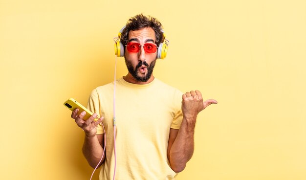 Expressive crazy man looking astonished in disbelief with headphones