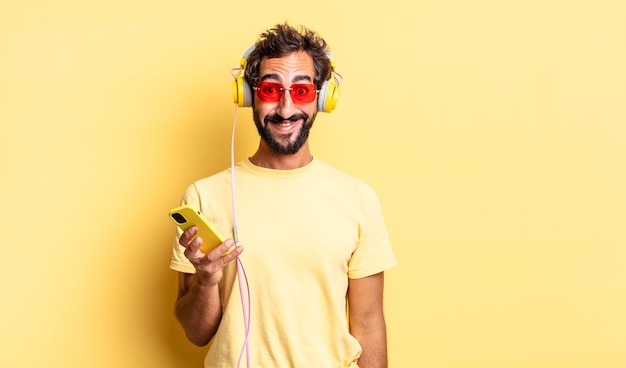 Expressive crazy man looking happy and pleasantly surprised with headphones