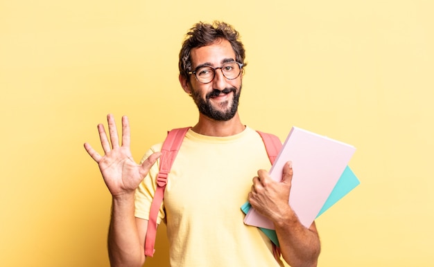 Expressive crazy man smiling and looking friendly, showing number five. adult student concept