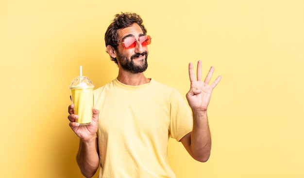 Expressive crazy man smiling and looking friendly showing number four