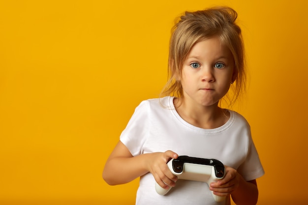 Expressive girl playing with game pad