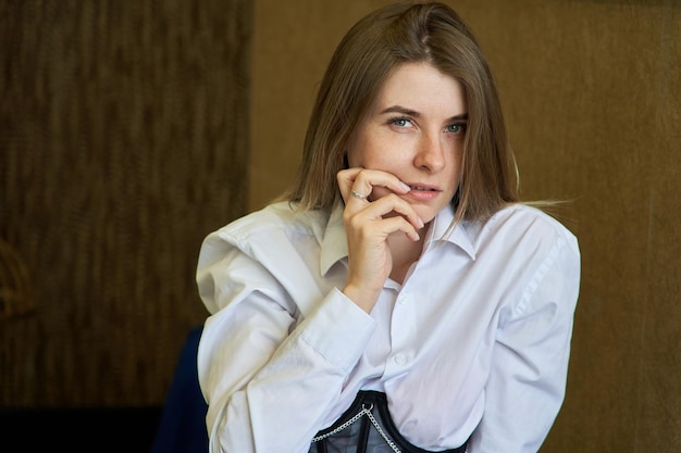 Expressive portrait of a young woman in a karset and a white shirt European girl close up