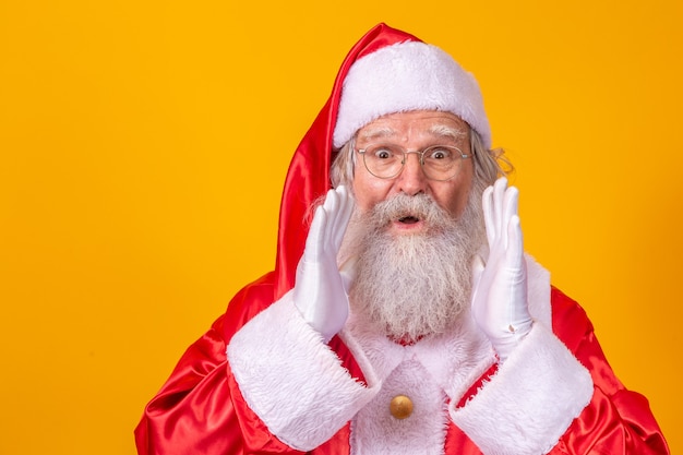 Expressive santa claus with his hand in his mouth excited about the christmas promotion