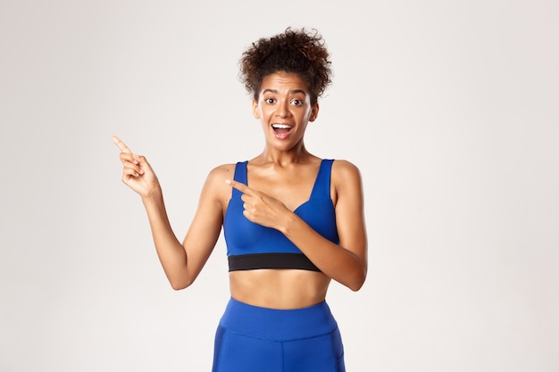 Expressive woman in fitness clothing posing