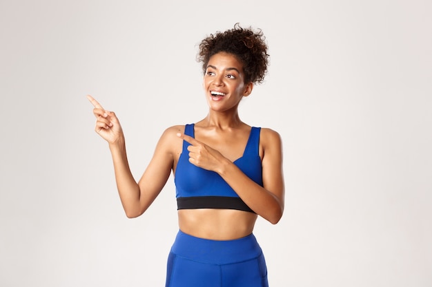 Expressive woman in fitness clothing posing