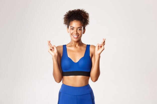 Expressive woman in fitness clothing posing