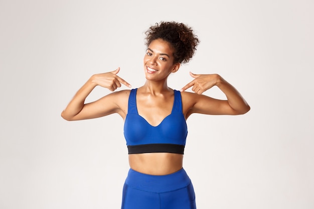 Expressive woman in fitness clothing posing