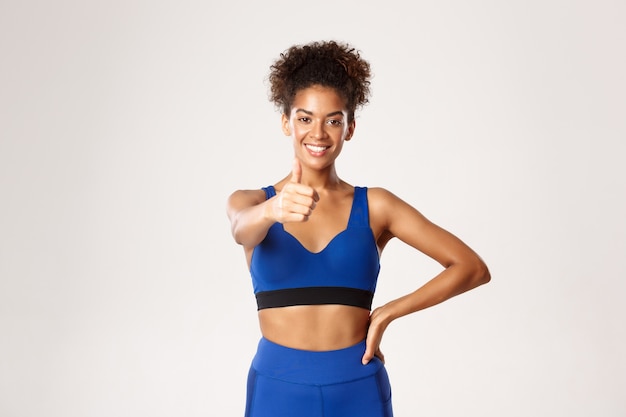 Expressive woman in fitness clothing posing