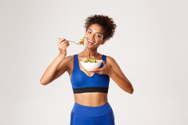 Expressive woman in fitness clothing posing