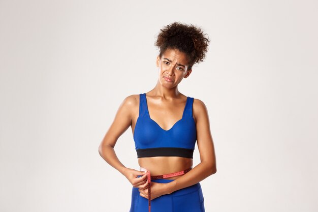 Expressive woman in fitness clothing posing