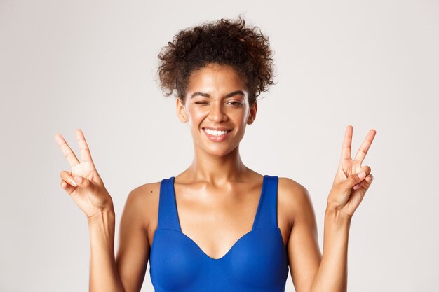 Expressive woman in fitness clothing posing