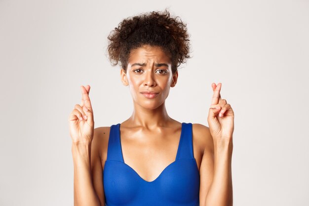 Expressive woman in fitness clothing posing