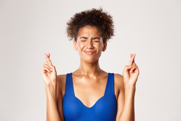 Expressive woman in fitness clothing posing