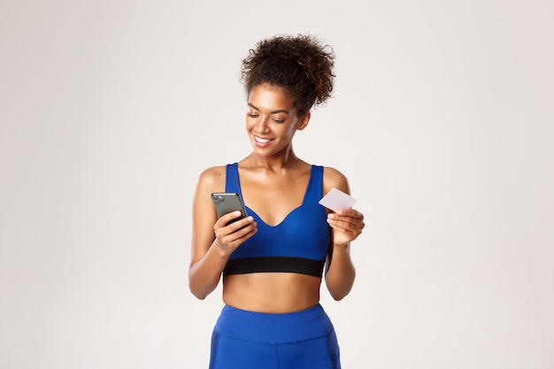 Expressive woman in fitness clothing posing