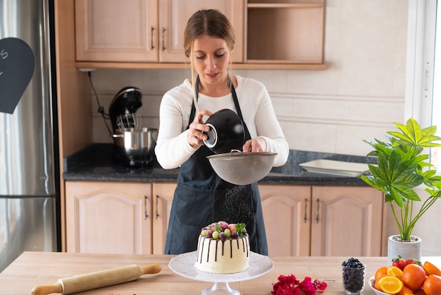 Expressive young woman cooking dessert