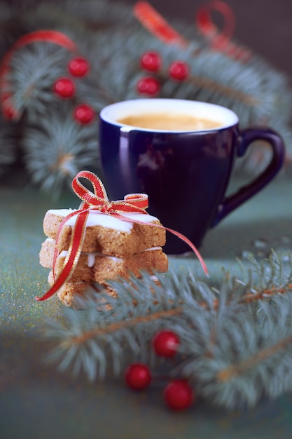 Expresso and stack of Christmas star cookies with green and red  Xmas decorations