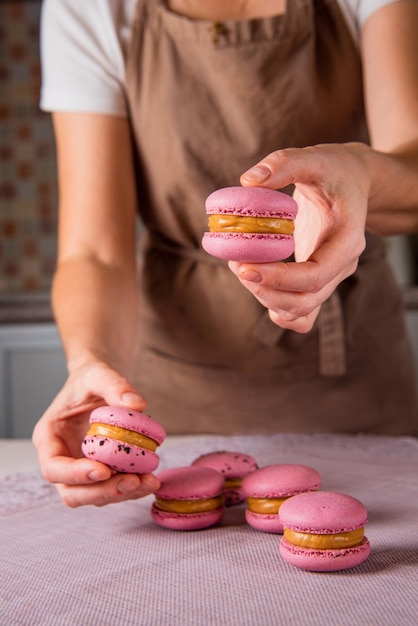 Exquisite handmade Macaroons in talented pastry Chef hands Delicious Delights