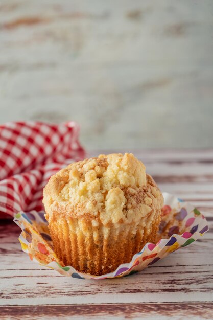 An Exquisite homemade cupcake or muffin with blueberries and blackberries cut in half on a rustic table. Homemade food, natural food. Copyspace.