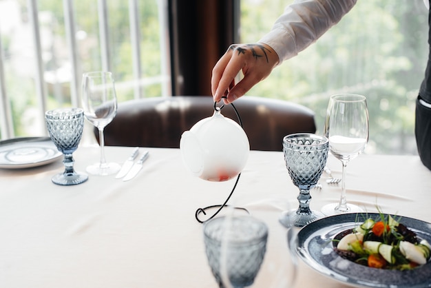 An exquisite salad of seafood, tuna and black caviar in a beautiful serving on the table in the restaurant. Exquisite delicacies of haute cuisine close-up.