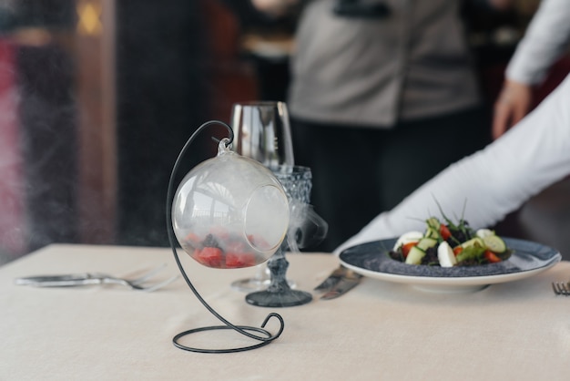 An exquisite salad of seafood, tuna and black caviar in a beautiful serving on the table in the restaurant. Exquisite delicacies of haute cuisine close-up.