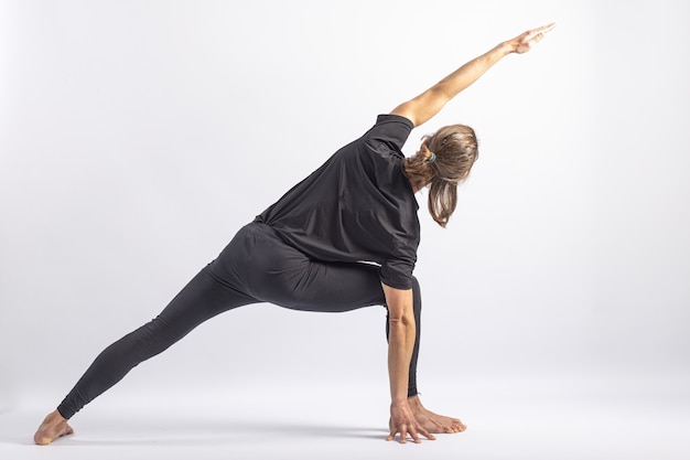 woman doing Extended Side Angle posture, Utthita Parsva Konasana Stock  Photo - Alamy