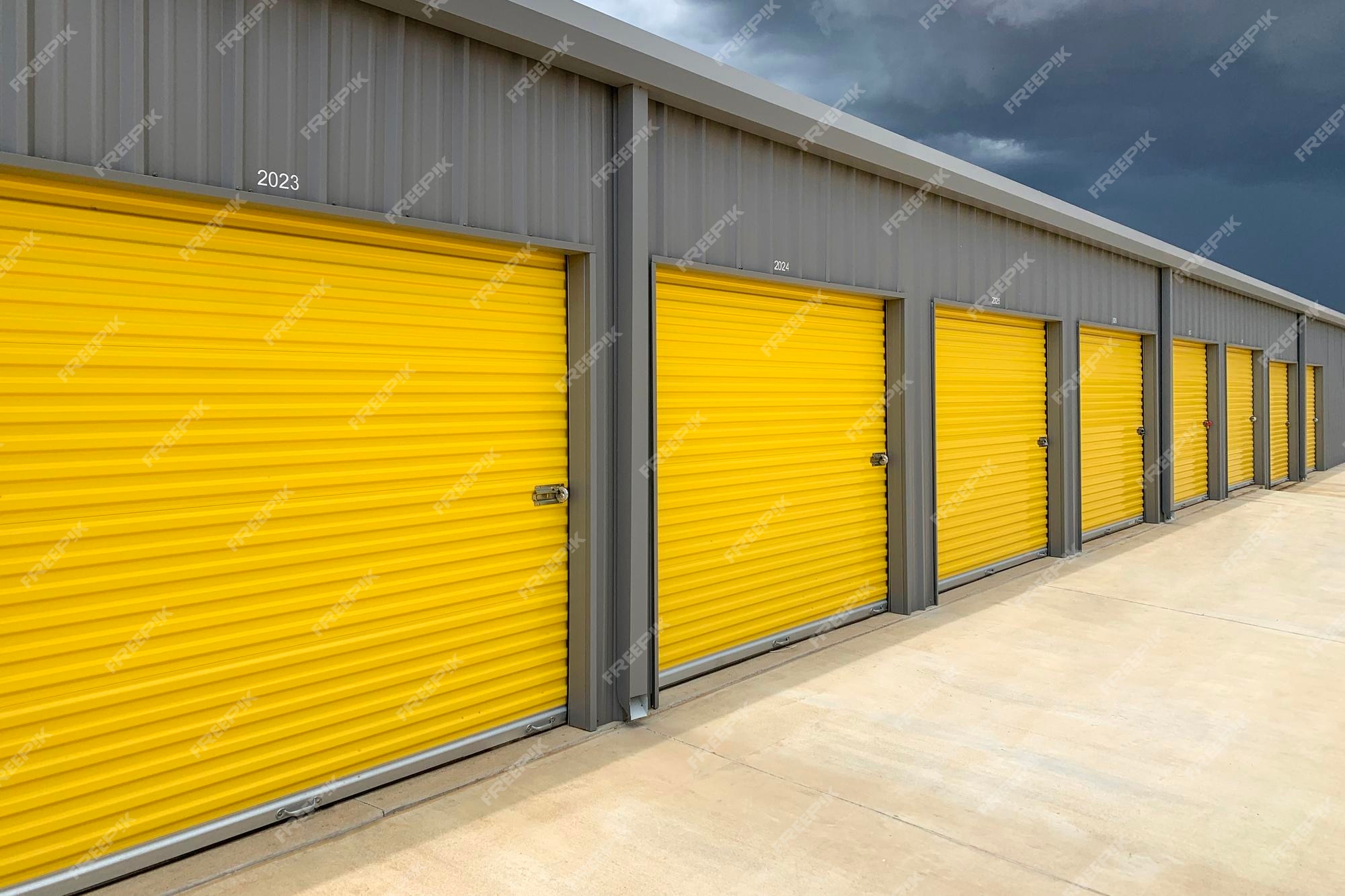 Extra Space Storage How To Open Door Premium Photo | Exterior of a commercial warehouse with yellow roller doors garages self storage facilities