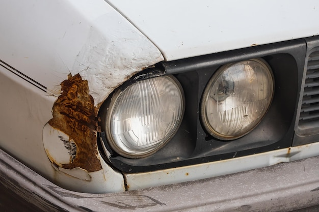 Exterior detail  close up  of  old headlight on rusty car