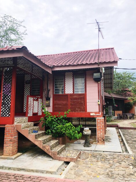 Exterior of house by building against sky