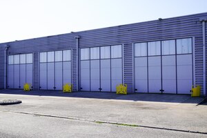 Photo exterior of modern distribution center warehouse grey door facade