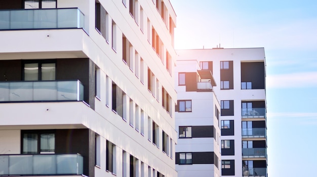 Exterior of new apartment buildings on a blue cloudy sky background No people