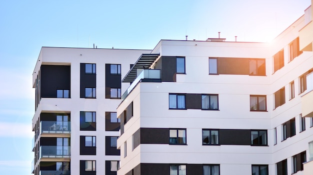 Exterior of new apartment buildings on a blue cloudy sky background No people