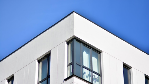 Exterior of new apartment buildings on a blue cloudy sky background No people