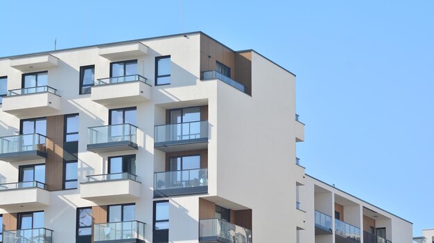 Exterior of new apartment buildings on a blue cloudy sky background No people