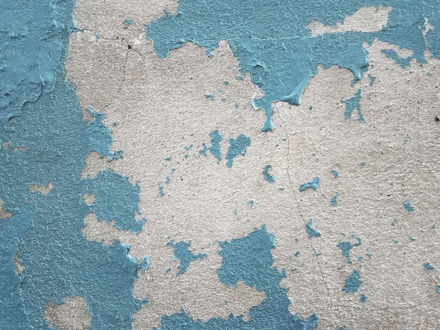 Exterior paint deteriorates on old cement floor The concrete wall is dirty with peeling paint for graphic design or wallpaper Vintage background in retro concept