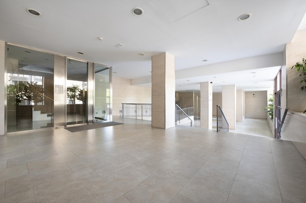 Exterior street portal of a residential building with cream marble flooring and tiles and a double metal door