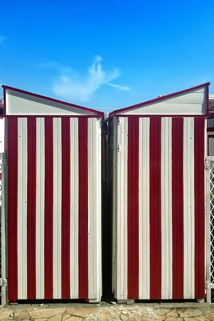 Photo exterior of striped beach hut